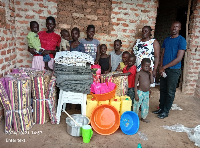 The above photo show a family given househole materials at Pece Pawel during home visit